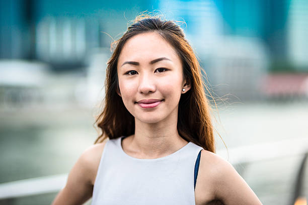 pretty asian woman standing outdoors